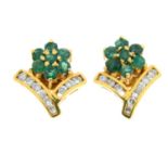 A pair of emerald and brilliant-cut diamond floral earrings.