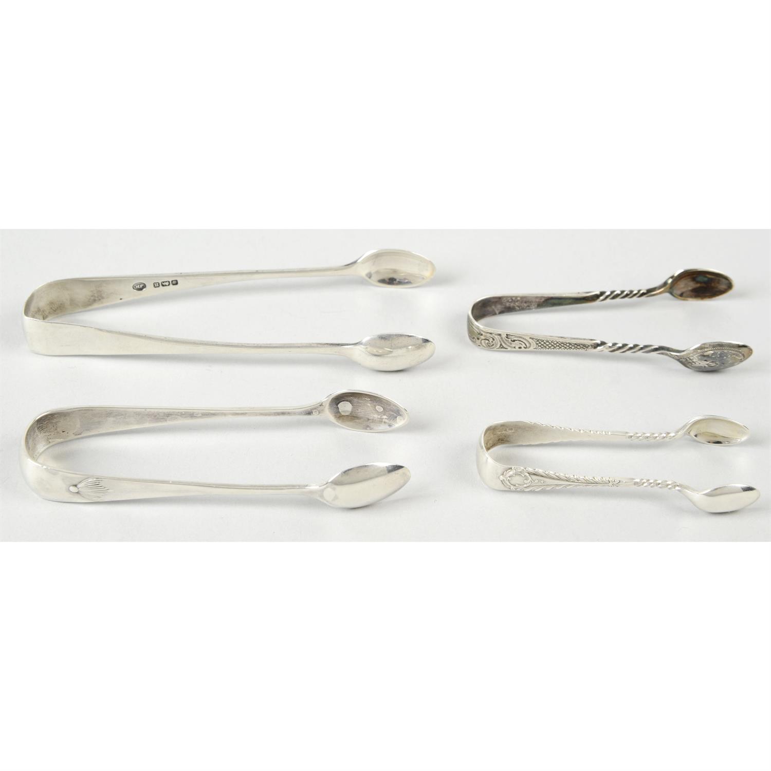 A pair of late Victorian small silver sugar tongs; together with three Edwardian silver pairs. (4).