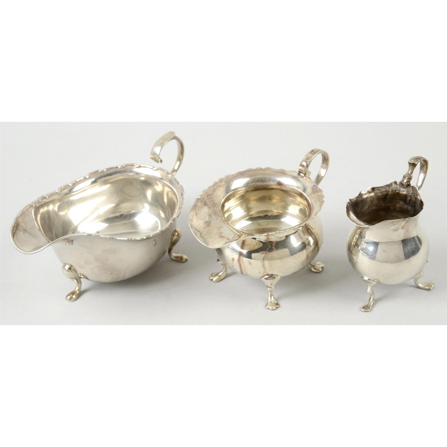 A late Victorian silver small cream jug, and a larger George V example; together with a 1930's