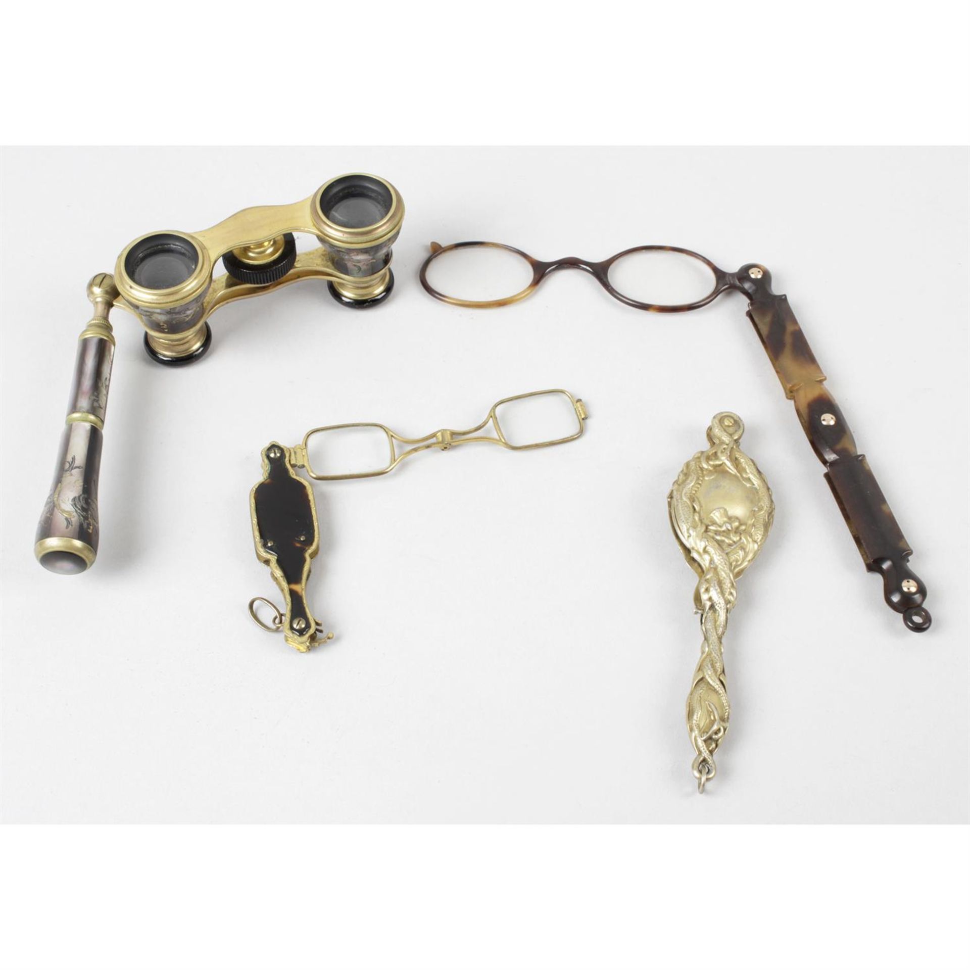 A pair of early twentieth century opera glasses, together with a pair of folding lorgnettes, etc.