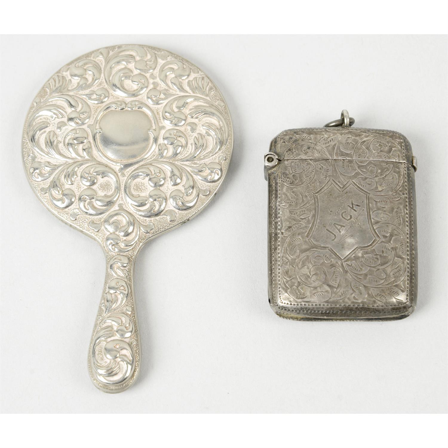 A late Victorian silver vesta case; together with a small hand-held mirror. (2).