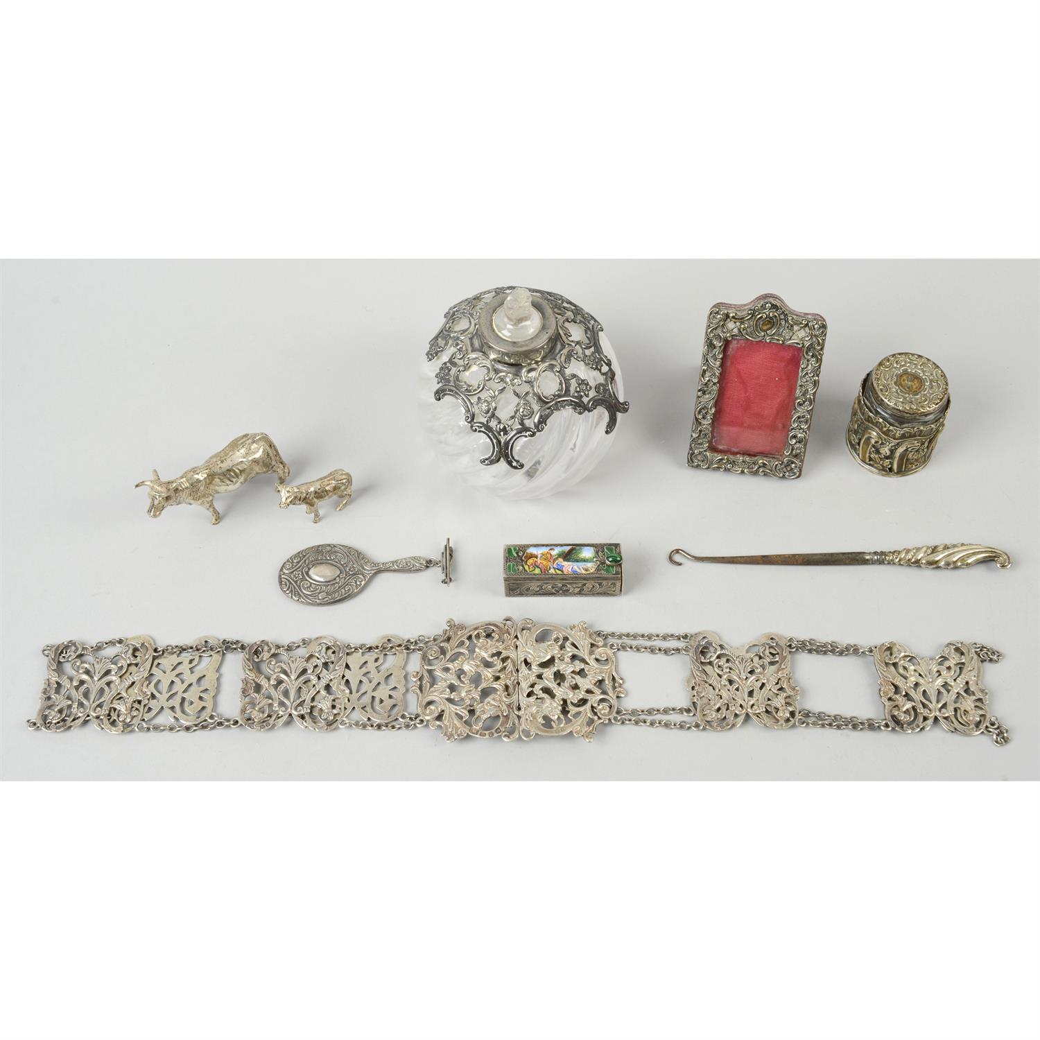 A late Victorian silver pierced belt; together with an Italian lipstick holder, two animal figures