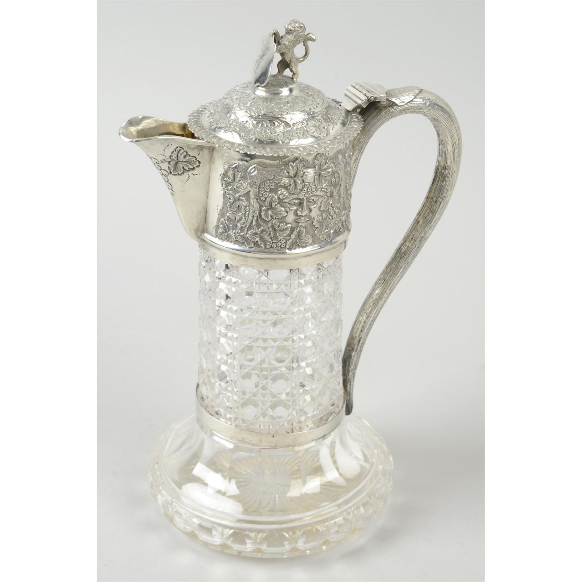 A late Victorian silver mounted and cut glass claret jug.