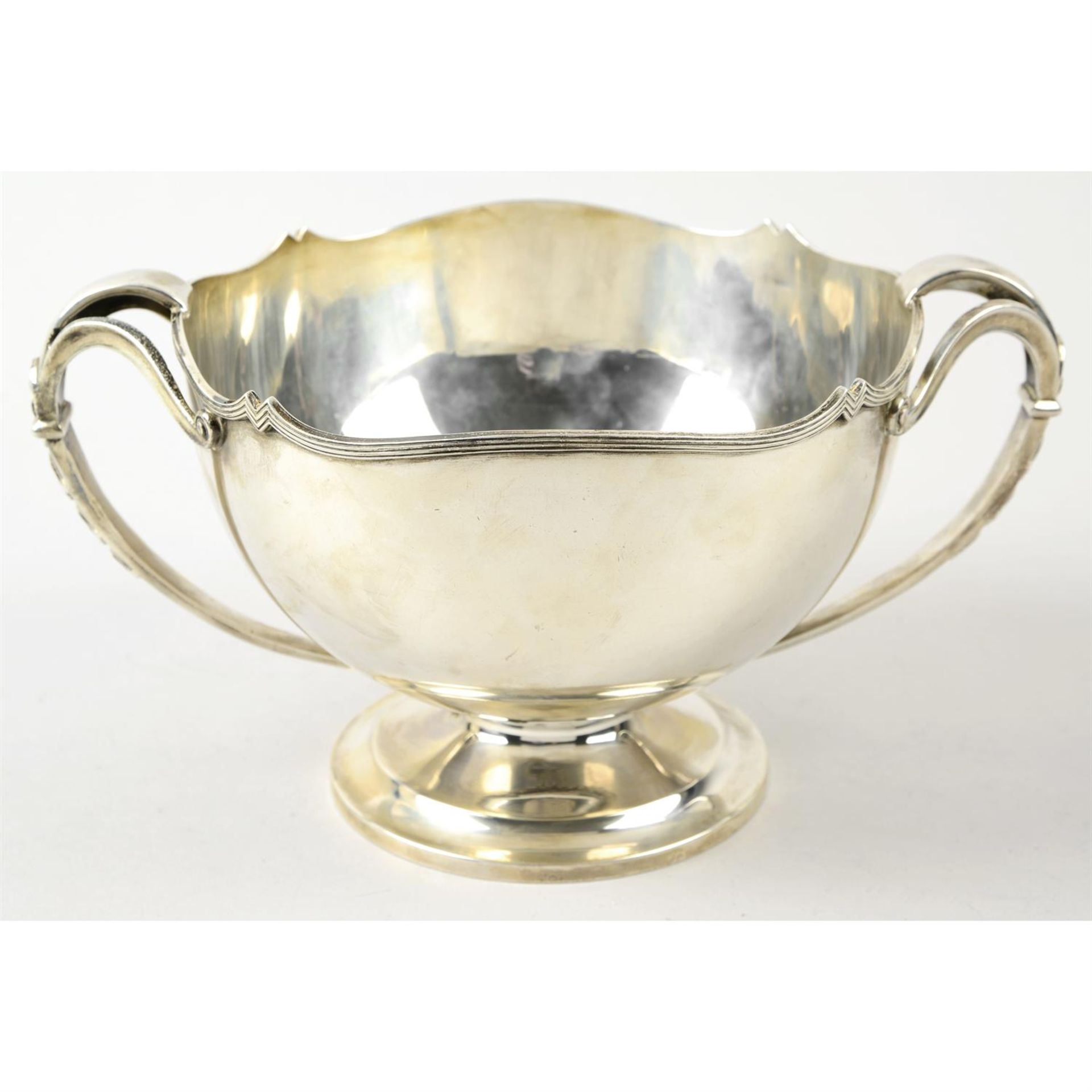 A George V silver twin-handled pedestal bowl.