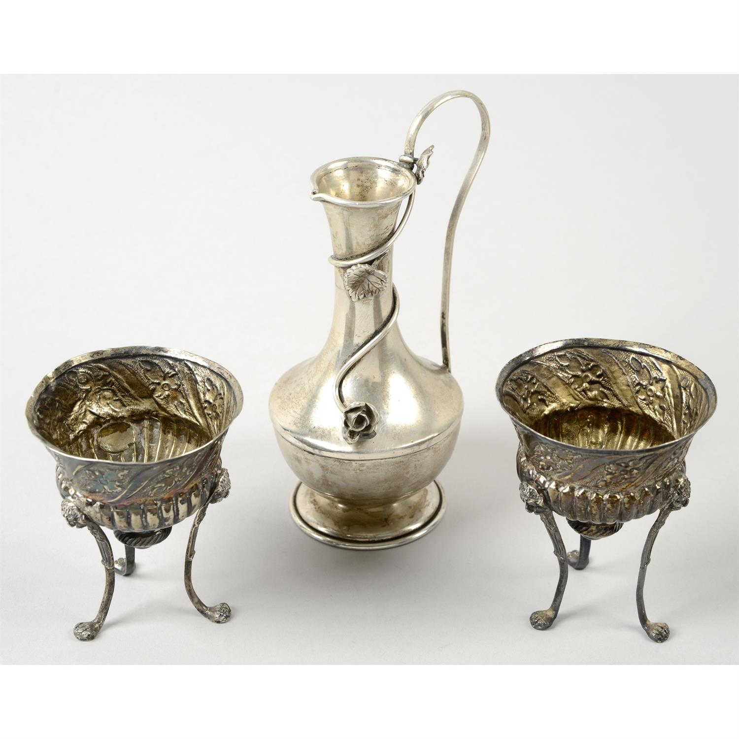 A small continental ewer; together with a pair of dishes on lion head supports.