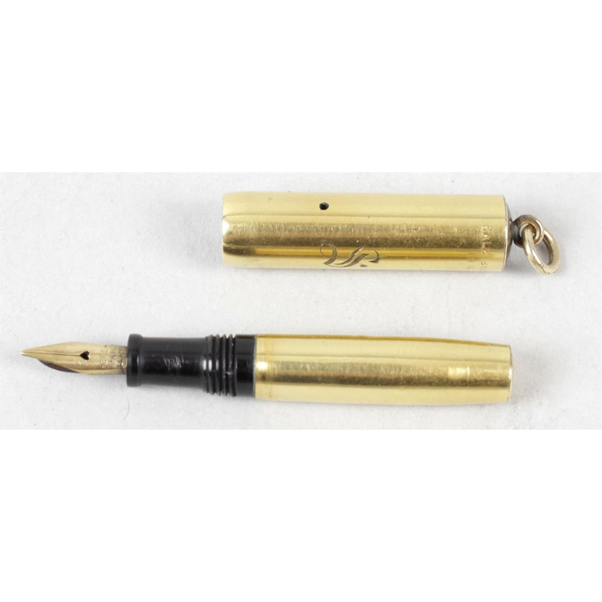 A small gold plated cased fountain pen.
