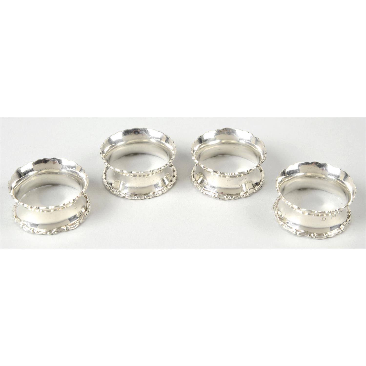 A matched set of four George V silver napkin rings by Walker & Hall; together with a pierced oval