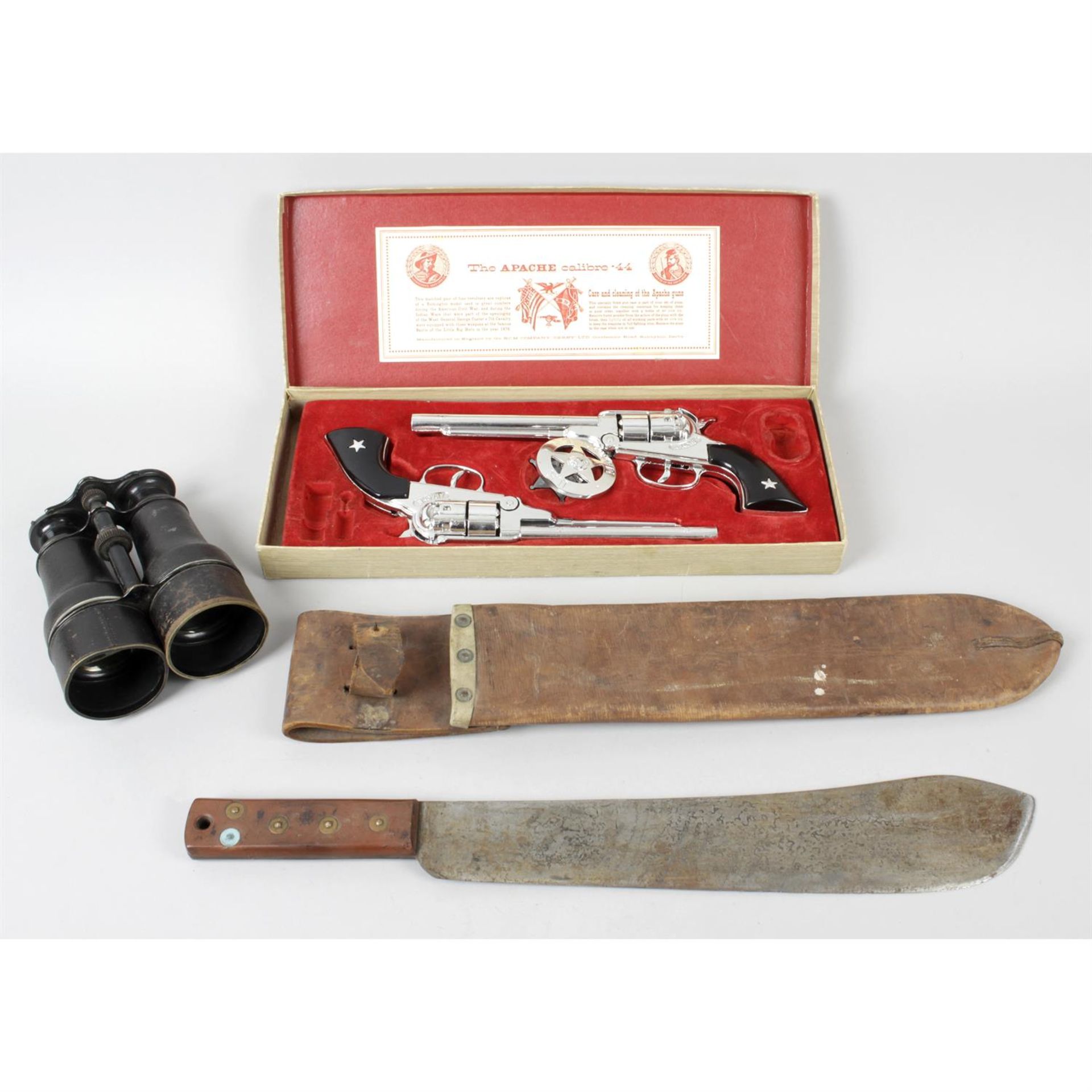 A selection of assorted militaria, to include a WWII machete, a pair of binoculars,