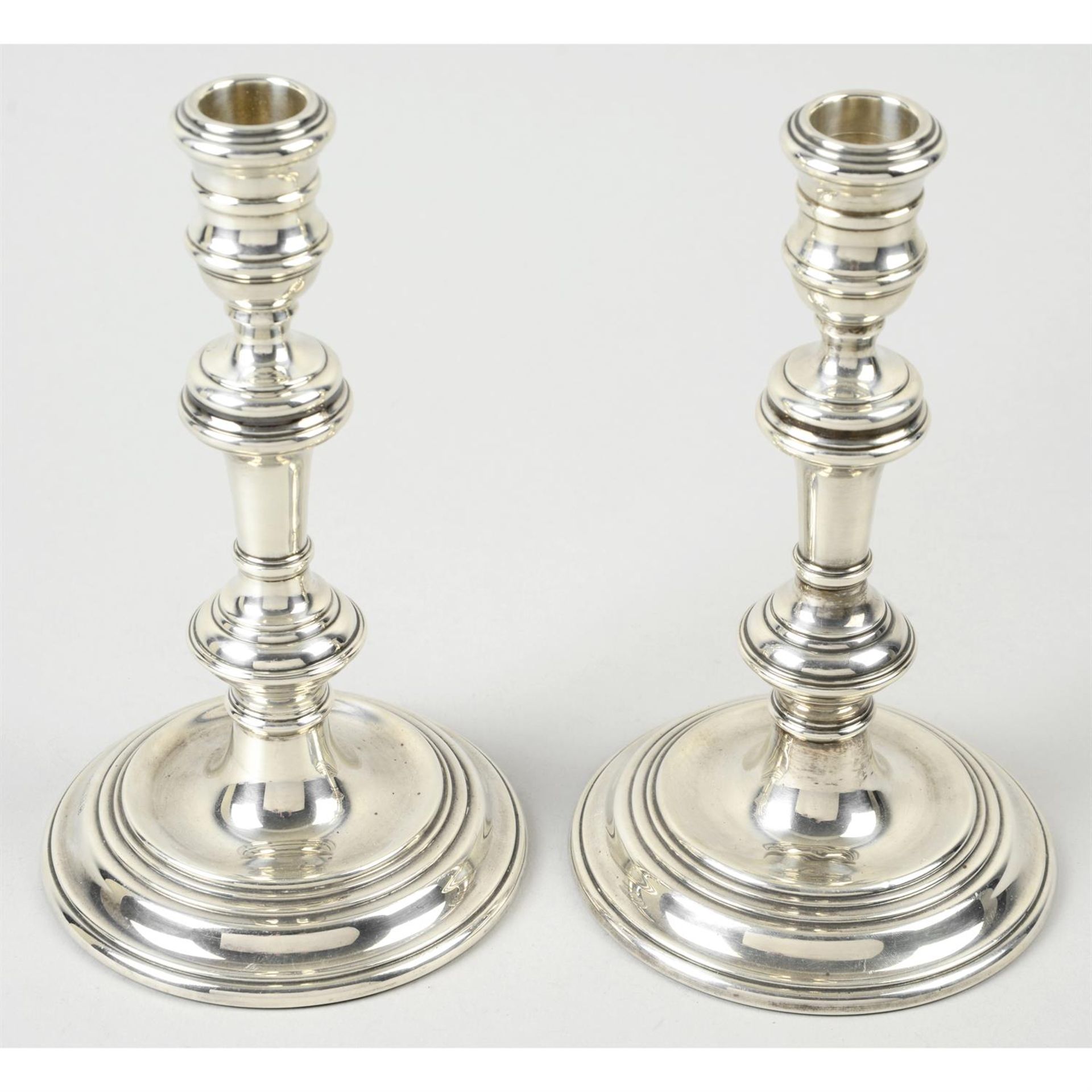 A pair of mid-20th century silver mounted candlesticks (filled).