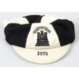 A Royal High School Edinburgh black and white panelled cap.