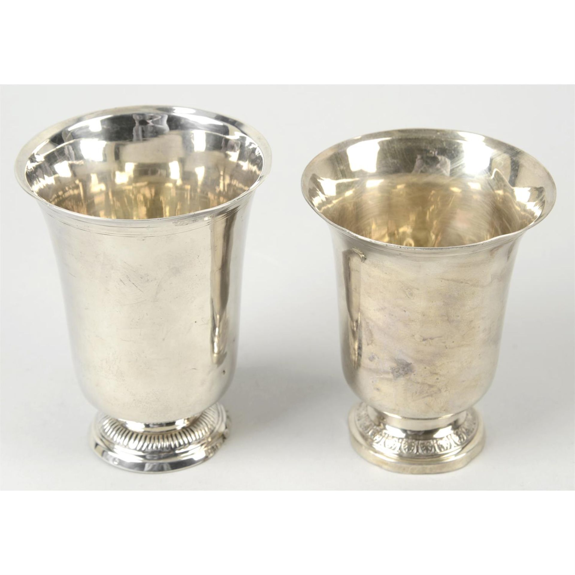 Two 19th century French silver beakers; together with two smaller cups. (4).