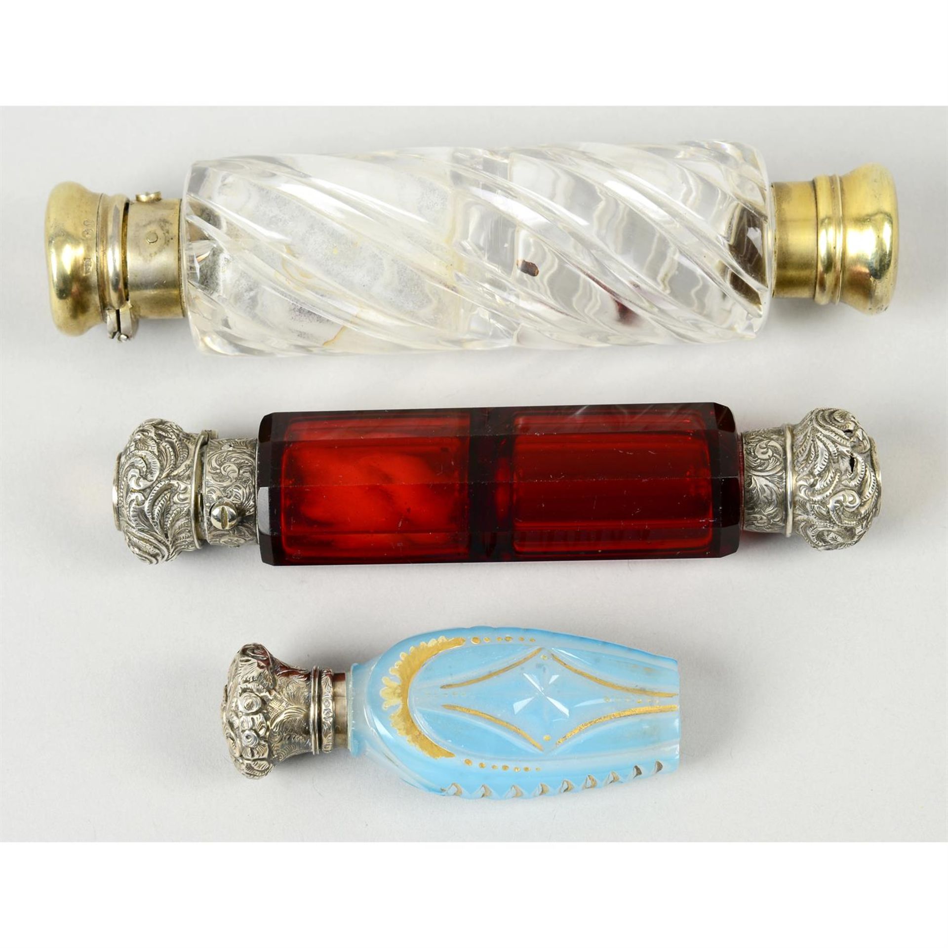 A Victorian wrythen glass double-ended scent bottle; together with a ruby glass example & a blue