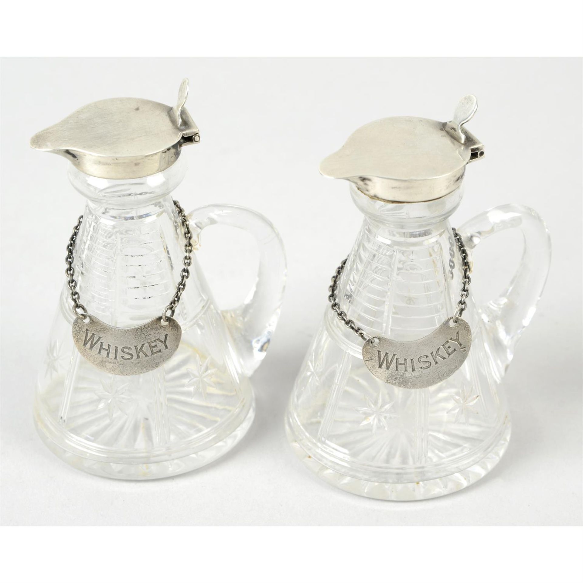 A pair of silver mounted & glass whiskey noggins.