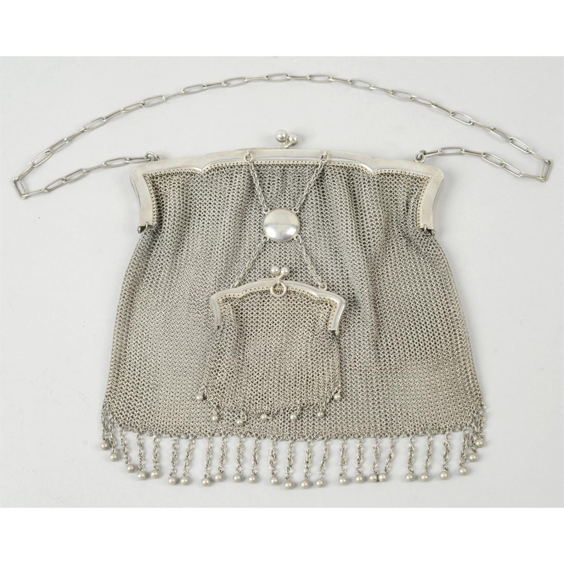 A silver mesh bag with attached mesh purse.