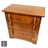 An early 20th Century stained pine chest of three long drawers with elliptical shaped handles,