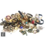 A parcel lot of assorted costume jewellery to include beads, rings, watches, bangle, brooches etc.