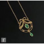 A modern 9ct emerald and diamond set open work pendant, three emeralds to a circular frame and