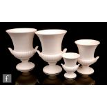A set of four mid 20th Century Wedgwood campana urns each glazed in moonstone white comprising a