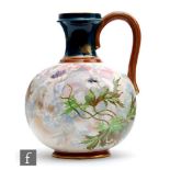 A late 19th to early 20th Century Doulton Burslem faience jug decorated with hand painted flowers