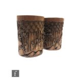 A pair of Chinese bamboo brushpots, Bitong, each of cylindrical form and carved in high relief to