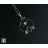 An early 20th Century 9ct open work pendant set with two green stones and central opal, suspended