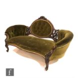 A Victorian serpentine-fronted sofa with exposed walnut frame, carved with foliate scroll detail