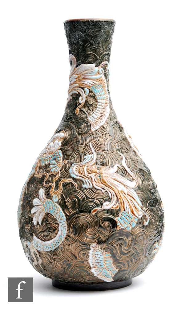 A late 19th Century Doulton Lambeth bottle vase decorated in relief with dragons heightened in