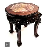 A Chinese Huanghuali style jardiniere stand, circa 1900, the lotus form top inset with a rouge