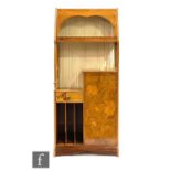 A French Art Nouveau marquetry inlaid salon display cabinet of asymmetrical form in the manner of