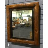 A 19th Century walnut cushion shaped wall mirror with internal hardwood slip frame, 67cm x 58cm, S/