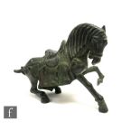 A Chinese bronze Tang style horse, with head lowered and leg raised, with good overall patination,
