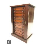 A late 19th to early 20th Century stained pine collectors cabinet in the form of a Wellington chest,