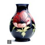 A Moorcroft Pottery baluster vase decorated in the Anemone pattern, impressed mark and numbered 34/