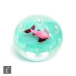 A Harland Paul Ysart paperweight internally decorated with a lamp work fish in pink and purple