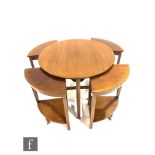 A 1930s nest of mahogany occasional tables raised to reeded legs, formed as a circular table with