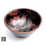 A studio pottery high sided footed bowl by Paul Green decorated with oxide brush strokes against a