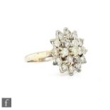 An 18ct hallmarked diamond cluster target ring comprising a daisy cluster of seven diamonds within a