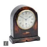 A 1920s oak cased mantle clock by Barraclough & Sons Ltd Leeds, silvered dial over a stepped base,