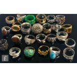 Twenty four assorted silver and white metal dress rings to include stones set and plain examples,