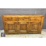 A 19th Century pine dresser base, the two plank top over three frieze drawers and cupboard base,