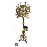 An early 20th Century brass ecclesiastical candle stand of lyre shaped lectern form, mounted with