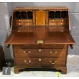 A George IV mahogany bureau with fall front and fitted interior above four graduated drawers and