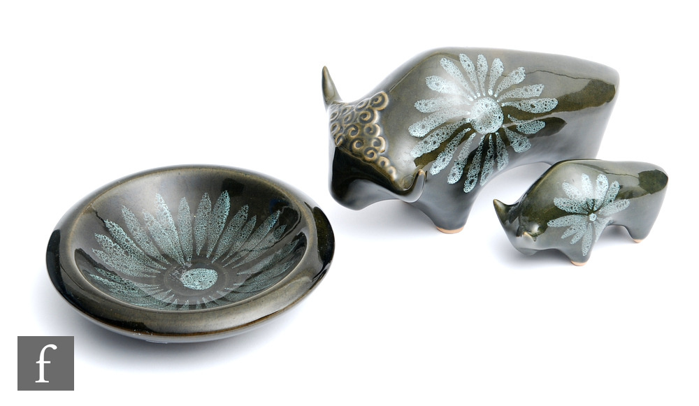 Two 1960s studio pottery models of bulls, both glazed in green with painted floral motif, unmarked