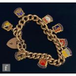 An early 20th Century 15ct curb link bracelet later converted to a charm bracelet with a 9ct padlock