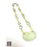 A mid 20th Century Chinese green hardstone pendant necklet, with alternating chain work and white