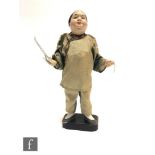 A Japanese traditional 'Musician' doll, circa 1920, modelled as a standing musician, the pottery