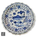 A large Chinese Kraak style blue and white charger, of circular form with scalloped lotus petal