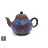 A Chinese 19th Century Yixing enamelled teapot of rounded form, with loop handle and short spout,