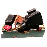 A Victorian mahogany cased and brass lens magic lantern converted to electricity and a collection of