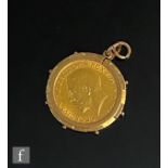 A George V full sovereign dated 1915, loose mounted to a 9ct mount, total weight 9.8g.
